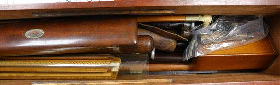 A mahogany rectangular box containing rulers, draughts, horn-handled penknives, etc.